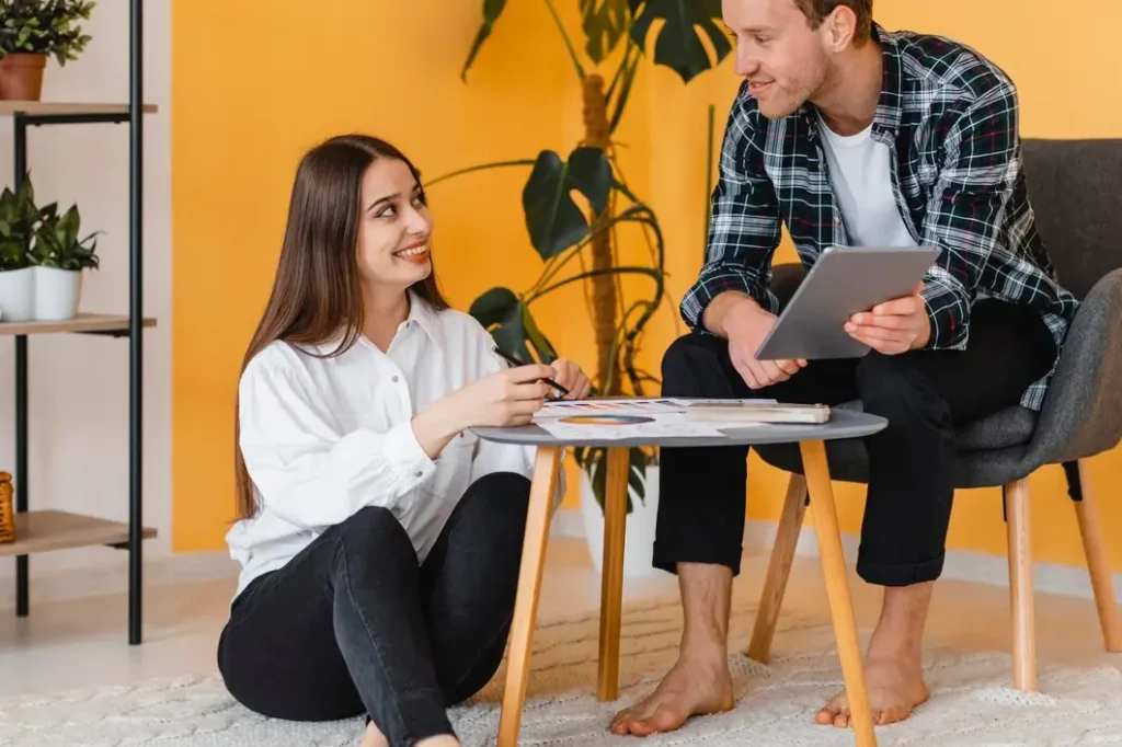 Couple discussing tenant rights in a cozy living space, featuring a table with documents and a tablet, emphasizing legal guidance for Medina County tenants.