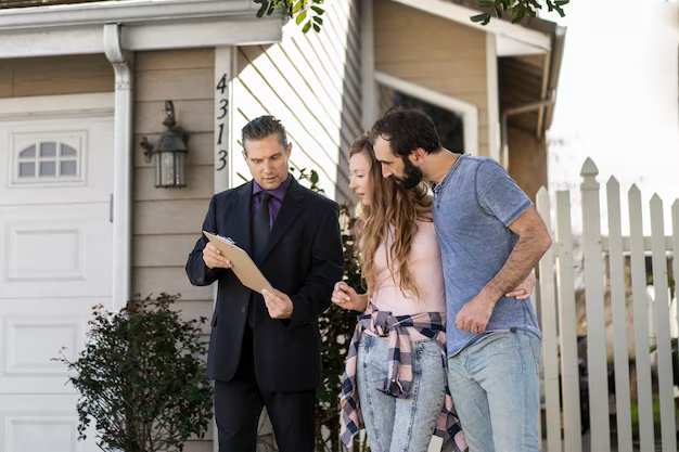 Man in a suit discussing tenant rights with a couple outside a house, highlighting legal assistance for renters in McQueeney, Texas.