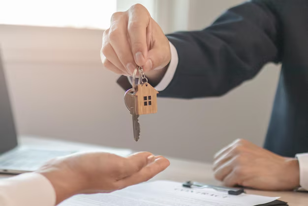 Hand handing over house keys to another person, symbolizing lease agreements and tenant rights in Texas.