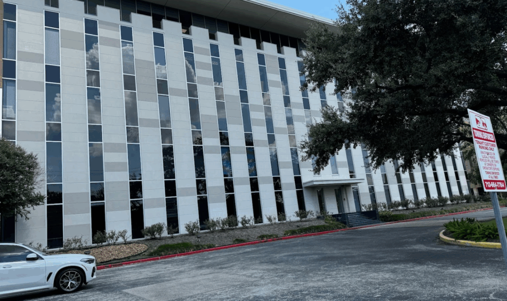 River Oaks office building of the Law Office of Bryan Fagan PLLC, featuring modern architecture, large windows, and surrounding greenery, located near Houston's prominent landmarks.
